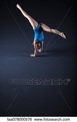 Gymnast doing handstand with legs split View Large Photo Image Stock Photograph - Gymnast doing handstand with legs split. Fotosearch