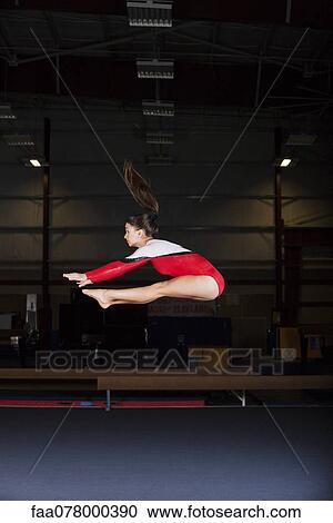 Gymnast jumping in air View Large Photo Image Stock Image - Gymnast jumping in air. Fotosearch