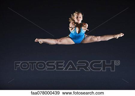 Stock Photo - Gymnast jumping in air. Fotosearch
