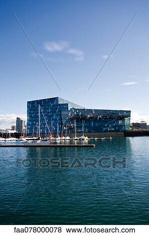Stock Photo - Iceland, Reykjavik, Harpa Concert Hall and marina viewed from harbor. Fotosearch