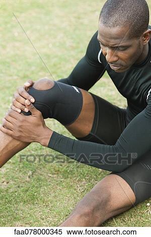 Male athlete wearing knee brace View Large Photo Image Stock Photography - Male athlete wearing knee brace. Fotosearch