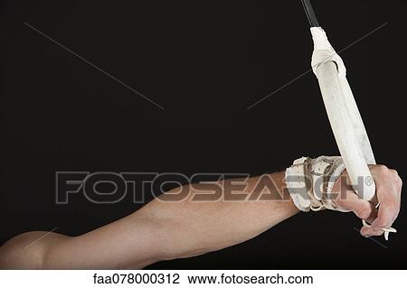 Male gymnast's hand holding onto gymnastics ring View Large Photo Image Stock Image - Male gymnast's hand holding onto gymnastics ring. Fotosearch