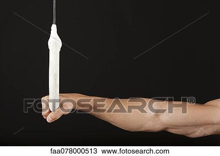 Stock Image - Male gymnast's hand holding onto gymnastics ring. Fotosearch