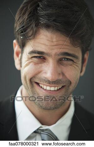 Stock Image - Man smiling happily, portrait. Fotosearch