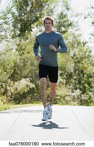 Stock Image - Mid-adult man jogging. Fotosearch