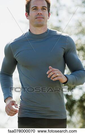 Stock Image - Mid-adult man running. Fotosearch