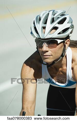 Stock Image - Mid-adult woman cyclist, portrait. Fotosearch