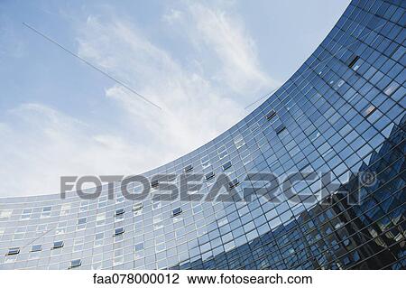 Stock Image - Modern curved building, low angle view. Fotosearch