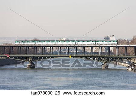 Paris metro crossing Pont de Bir-Hakeim, Paris, France View Large Photo Image Stock Photograph - Paris metro crossing Pont de Bir-Hakeim, Paris, France. Fotosearch
