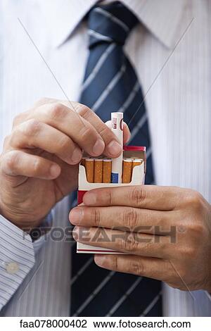Removing rolled euro from cigarette pack View Large Photo Image Stock Image - Removing rolled euro from cigarette pack. Fotosearch
