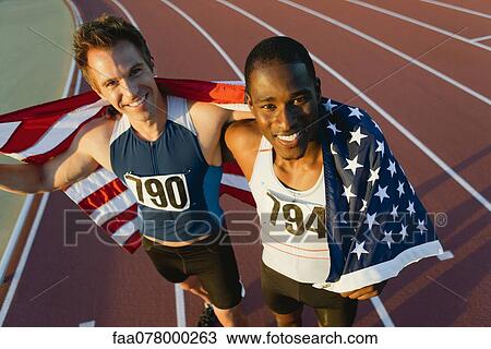 Running teammates holding up American flag after race View Large Photo Image Stock Image - Running teammates holding up American flag after race. Fotosearch