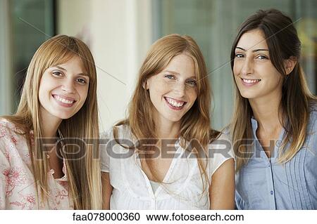Stock Image - Smiling young women, portrait. Fotosearch
