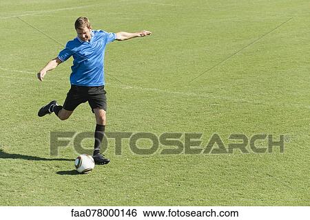 Soccer player kicking soccer ball on soccer field View Large Photo Image Stock Photograph - Soccer player kicking soccer ball on soccer field. Fotosearch