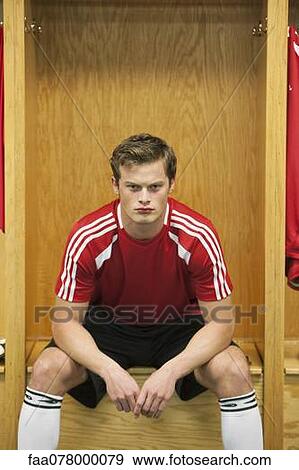 Stock Photo - Soccer player sitting in locker room. Fotosearch