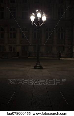 Stock Photography - Street lamp illuminated at night in Place de l'Hotel de Ville, Paris, France. Fotosearch