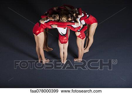 Team of gymnasts huddling View Large Photo Image Stock Photo - Team of gymnasts huddling. Fotosearch