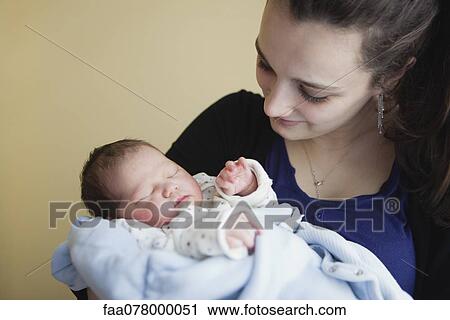 Teenage girl holding newborn baby View Large Photo Image Stock Image - Teenage girl holding newborn baby. Fotosearch