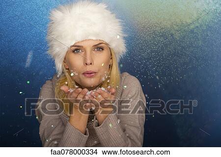 Woman blowing handful of confetti, portrait View Large Photo Image Picture - Woman blowing handful of confetti, portrait. Fotosearch