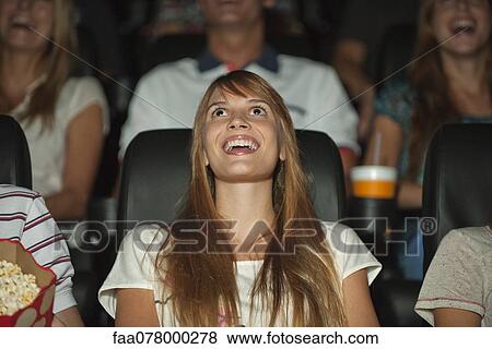 Woman laughing in movie theater View Large Photo Image Stock Photo - Woman laughing in movie theater. Fotosearch