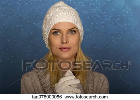 Stock Photograph - Woman wearing knit hat and gloves, portrait. Fotosearch