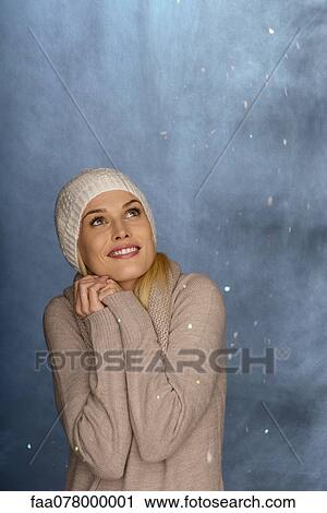 Woman wearing knit hat in front of snowy background, portrait View Large Photo Image Stock Image - Woman wearing knit hat in front of snowy background, portrait. Fotosearch