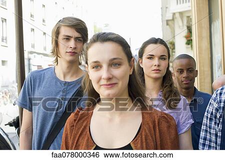 Stock Photograph - Young adults walking on sidewalk. Fotosearch