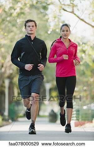 Young couple jogging side by side View Large Photo Image Stock Photo - Young couple jogging side by side. Fotosearch