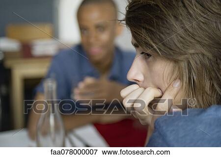 Stock Photo - Young man looking away in thought. Fotosearch