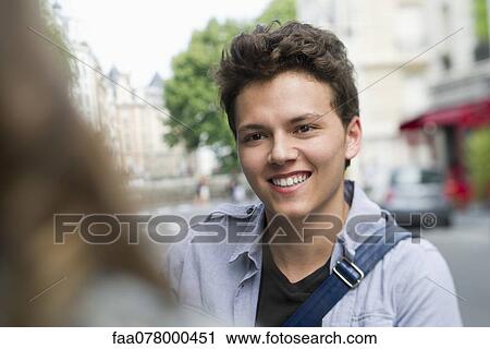 Young man outdoors, smiling View Large Photo Image Stock Image - Young man outdoors, smiling. Fotosearch