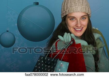 Young woman carrying Christmas shopping bags, portrait View Large Photo Image Stock Image - Young woman carrying Christmas shopping bags, portrait. Fotosearch