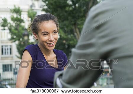 Young woman hanging out with friend outdoors View Large Photo Image Stock Photo - Young woman hanging out with friend outdoors. Fotosearch
