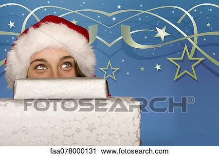 Young woman peeking over stack of Christmas gifts View Large Photo Image Stock Image - Young woman peeking over stack of Christmas gifts. Fotosearch