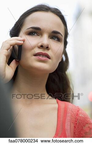 Young woman using cell phone View Large Photo Image Picture - Young woman using cell phone. Fotosearch