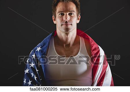 Stock Photography - Athlete covered with American flag, portrait. Fotosearch