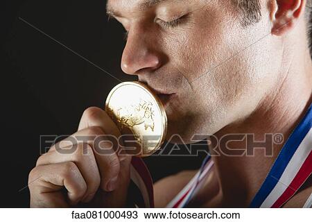 Athlete kissing gold medal View Large Photo Image Stock Image - Athlete kissing gold medal. Fotosearch