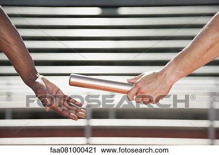 Athletes passing baton, cropped View Large Photo Image Stock Image - Athletes passing baton, cropped. Fotosearch