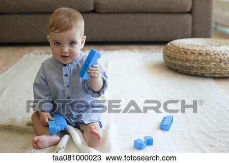 Stock Image - Baby boy playing with building blocks. Fotosearch