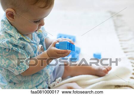 Stock Photo - Baby boy playing with building blocks. Fotosearch