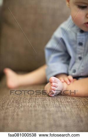 Stock Photo - Baby boy sitting, cropped. Fotosearch