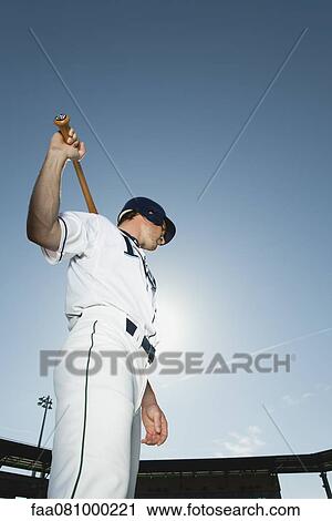 Baseball player holding baseball bat across shoulders View Large Photo Image Stock Image - Baseball player holding baseball bat across shoulders. Fotosearch