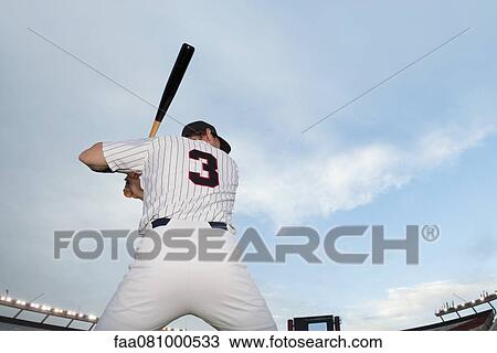Stock Image - Baseball player preparing to bat, rear view. Fotosearch