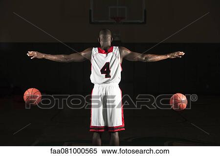 Stock Photography - Basketball player dribbling two balls. Fotosearch
