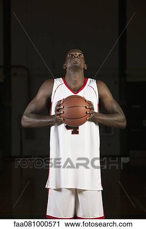 Basketball player holding basketball, portrait View Large Photo Image Stock Image - Basketball player holding basketball, portrait. Fotosearch