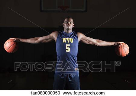 Basketball player holding basketballs in both hands View Large Photo Image Stock Image - Basketball player holding basketballs in both hands. Fotosearch