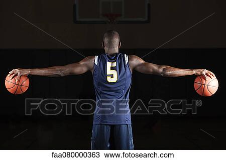 Basketball player holding basketballs in both hands, rear view View Large Photo Image Stock Image - Basketball player holding basketballs in both hands, rear view. Fotosearch