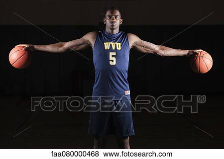 Basketball player holding basketballs in both hands View Large Photo Image Stock Photo - Basketball player holding basketballs in both hands. Fotosearch