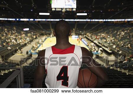 Basketball player looking down at stadium, rear view View Large Photo Image Stock Photo - Basketball player looking down at stadium, rear view. Fotosearch