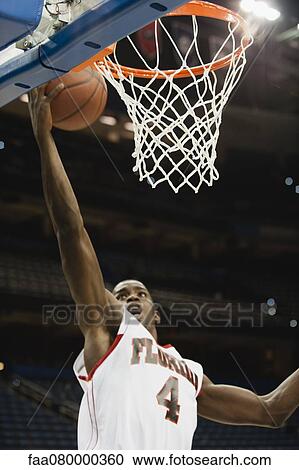 Basketball player making a basket View Large Photo Image Stock Image - Basketball player making a basket. Fotosearch