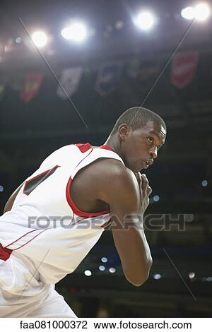 Stock Image - Basketball player with basketball. Fotosearch