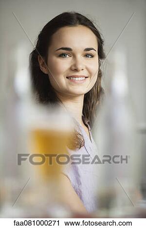 Beautiful young woman, focus on background View Large Photo Image Stock Image - Beautiful young woman, focus on background. Fotosearch